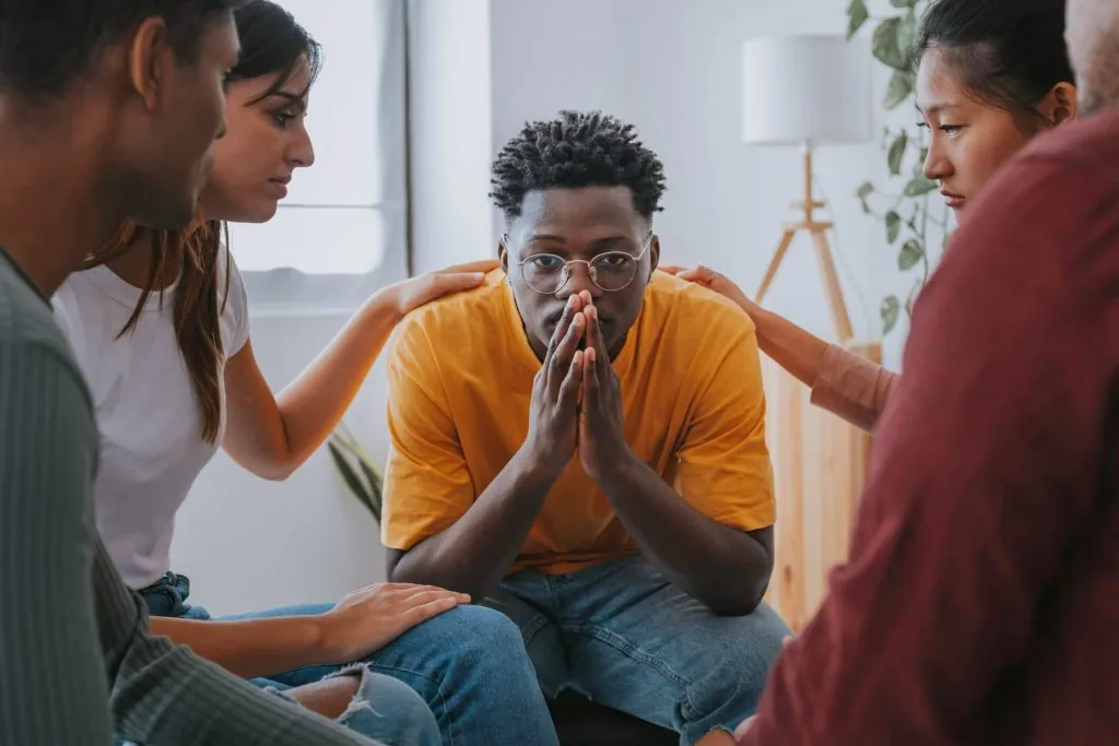 Men getting help from group