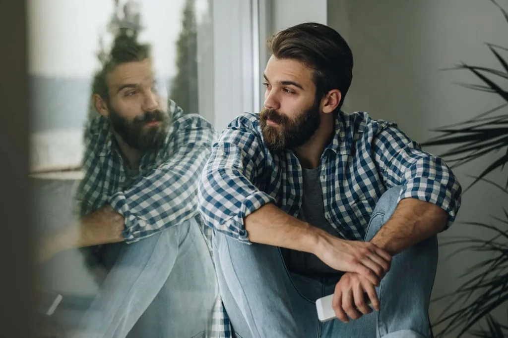 Man relaxing on window