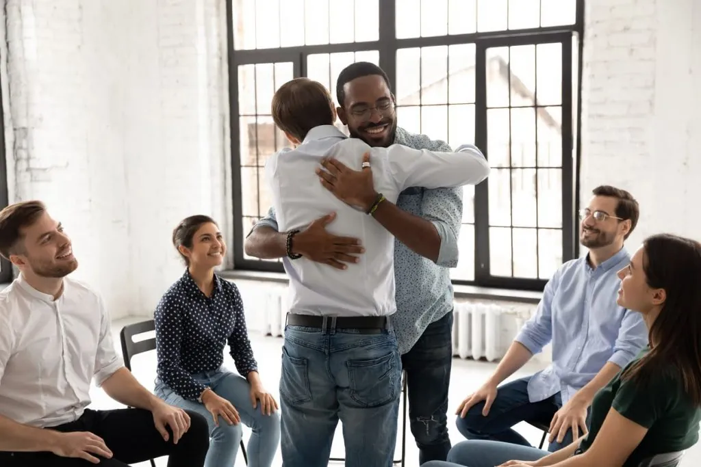 hugging in front of group